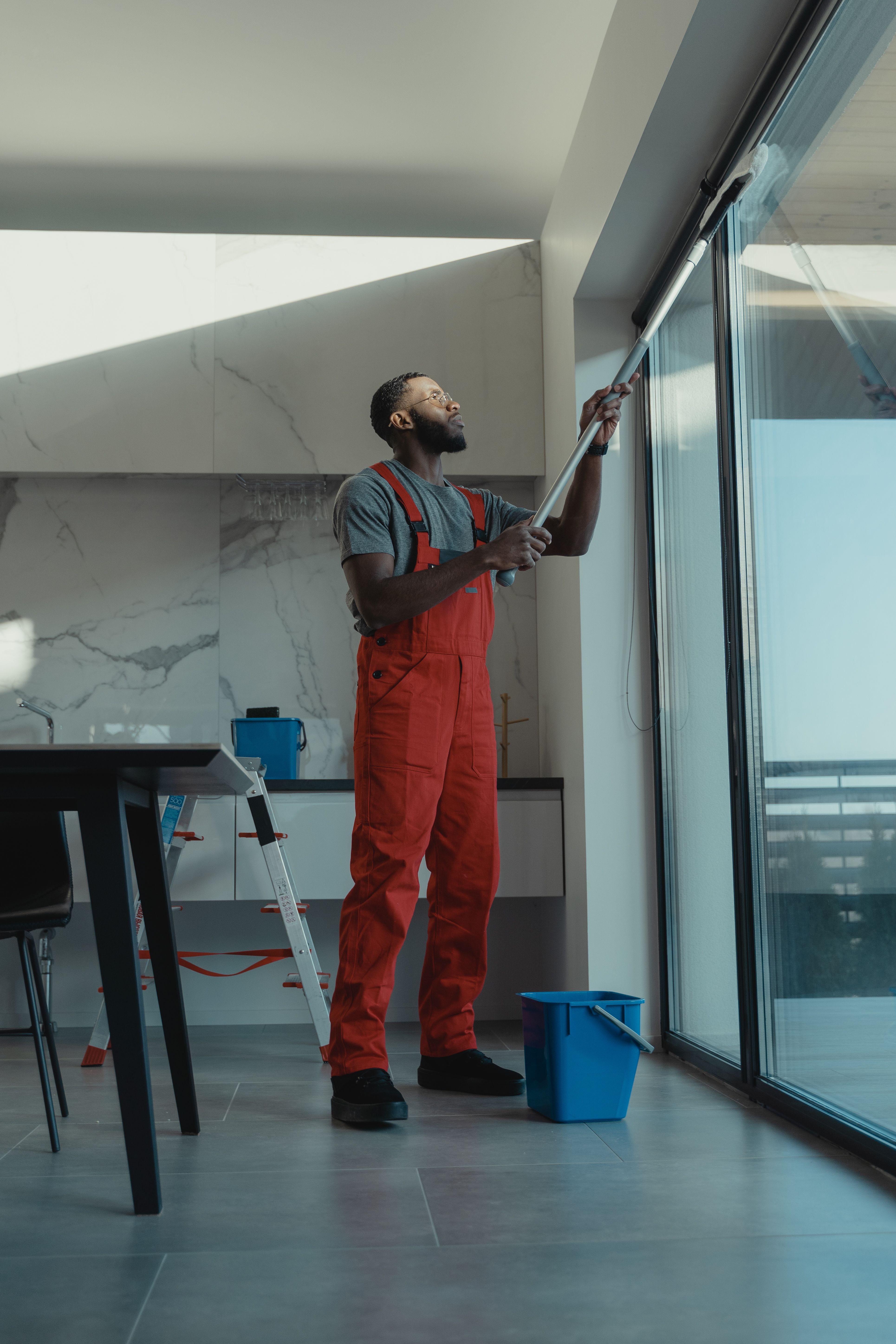 Cleaning technician wiping down a glass door